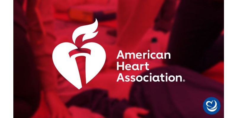 American Heart Association logo overlaid on image of student practicing CPR on Laerdal Resusci Anne.