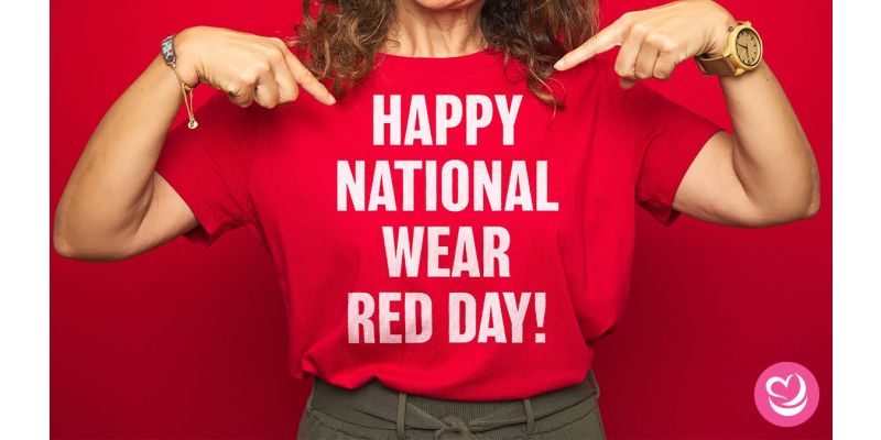 Woman pointing to her red t-shirt that reads "HAPPY NATIONAL WEAR RED DAY!"